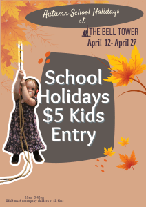 A young girl chimes a bell with autumn leaves in hte background. 'School Holidays $5 Kids Entry' behind her.