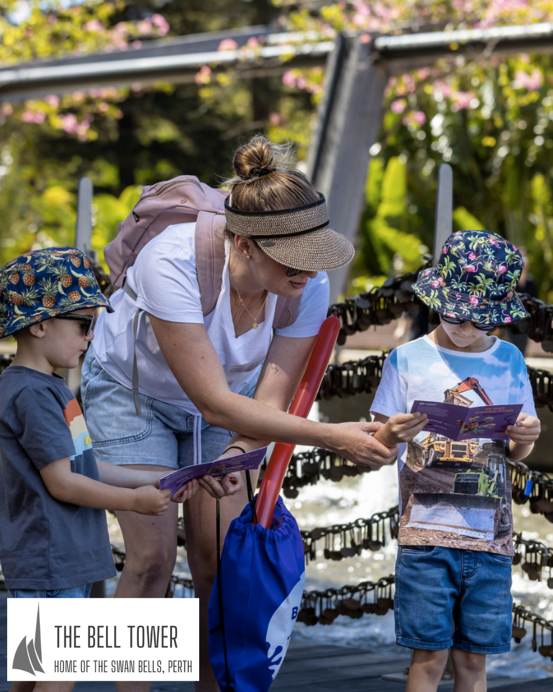 A mother helps her two children complete a Busy Pack, available to prchase at The Bell Tower