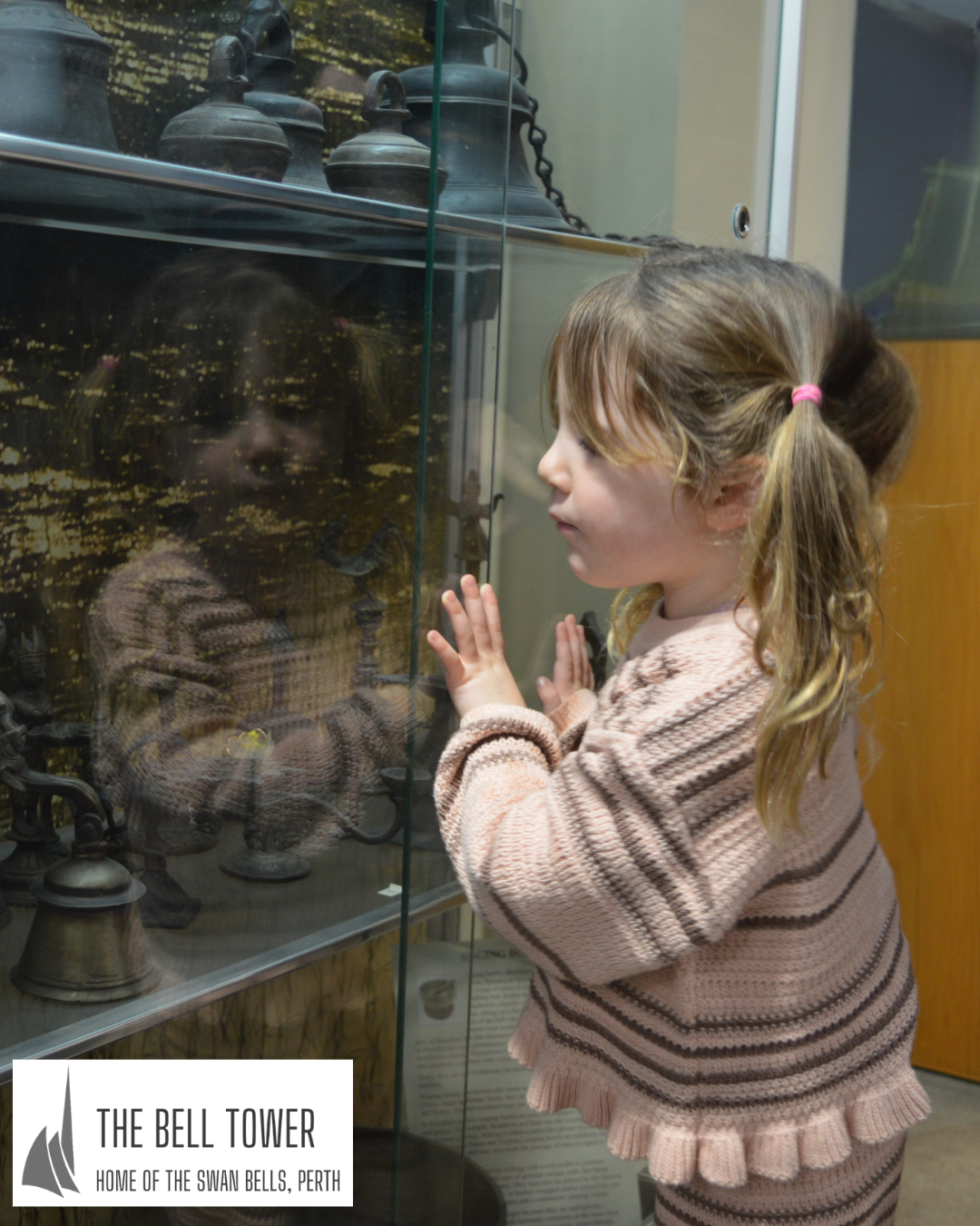 A young girl looks at the exhibits in The Bell Tower